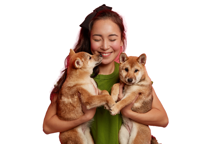 Women hugging her two dogs, with bright smile over her face. Feels the love towards her pets